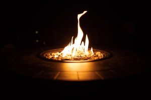 a fire pit with a fire in the middle of the fire - gas fire pit at night